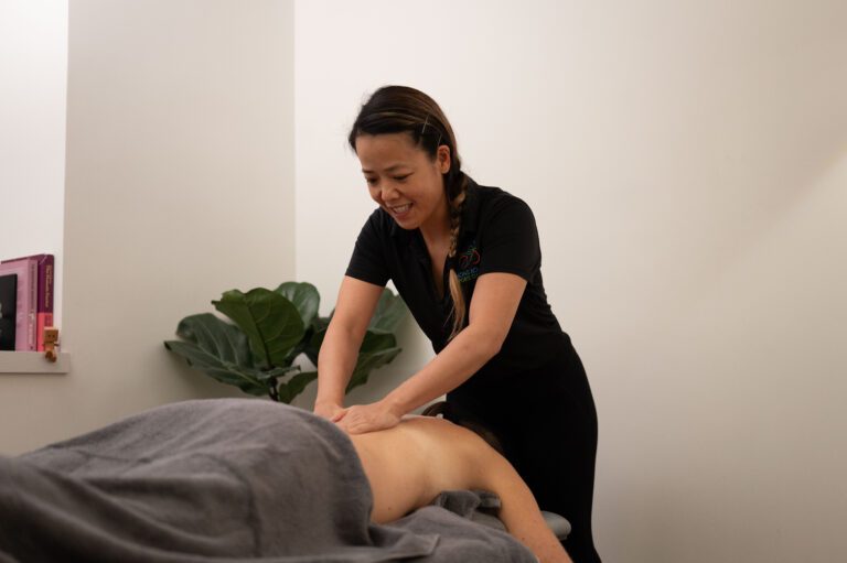 Therapist treating a patient on a treatment table