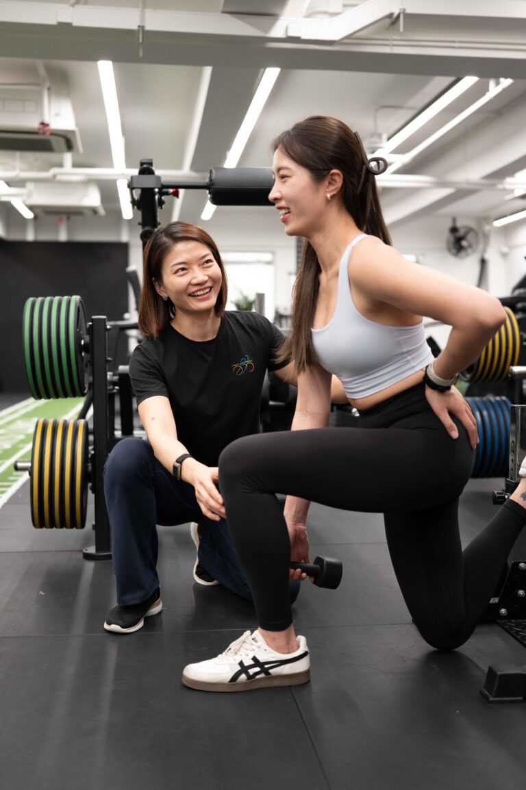 Coach discussing a training plan with a client in the gym
