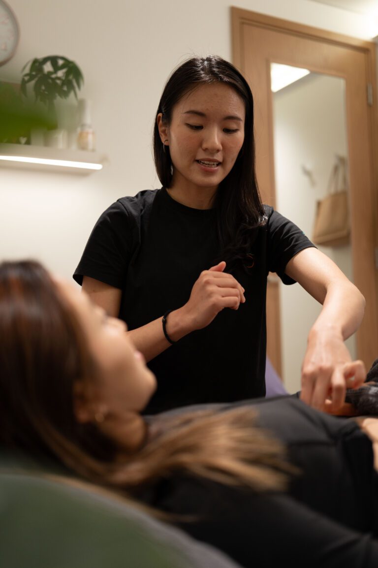 Therapist treating a patient's neck and shoulder