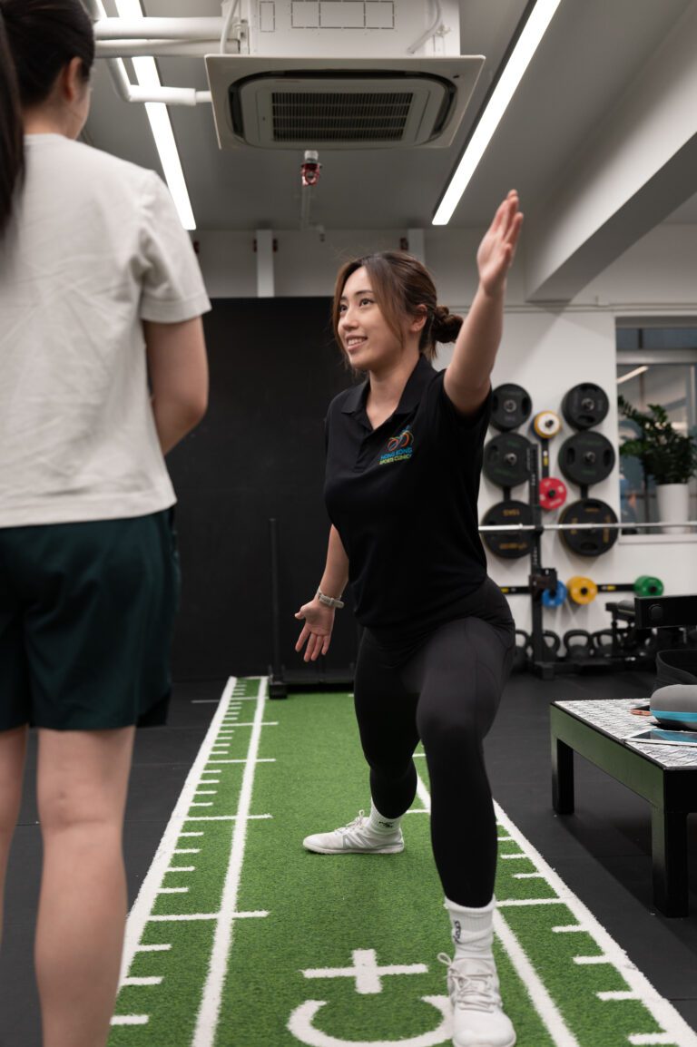 Therapist demonstrating a rehabilitation exercise in the gym