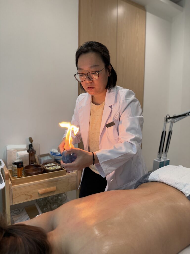 Dr. Grace Yu treating a patient with cupping therapy.