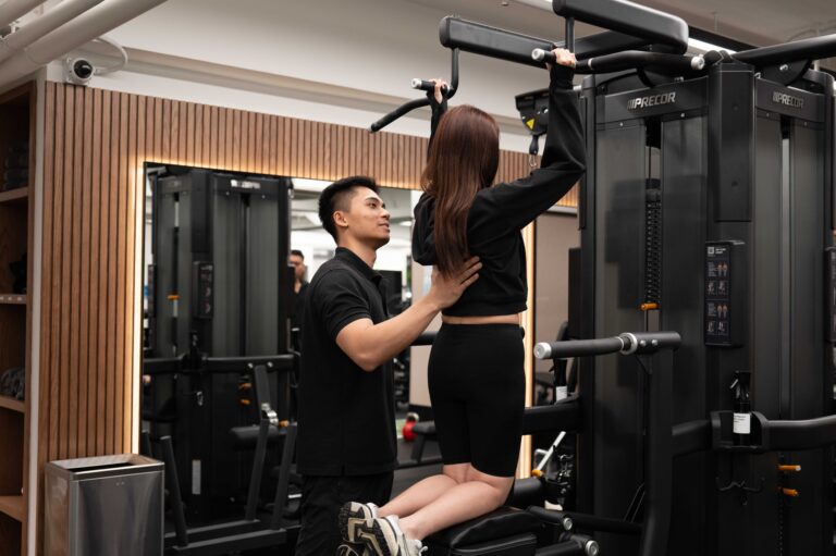 Trainer and client at the cable machine in the Total Health gym
